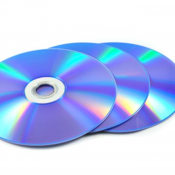 Three blank dvds on a white desk